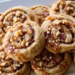 Sweet caramel and chopped nut-studded cookies with a soft, crumbly texture and golden-brown edges, perfect for snacking or gift-giving.