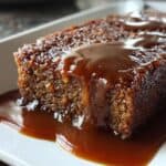 Decadent caramel sauce drizzling over moist and flavorful homemade dessert cake, topped with caramel glaze. Perfect for sweet cravings and special occasions.
