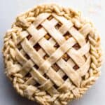 Freshly baked apple pie with a decorative lattice crust, showcasing flaky, golden pastry and warm apple filling, perfect for fall desserts and family gatherings.