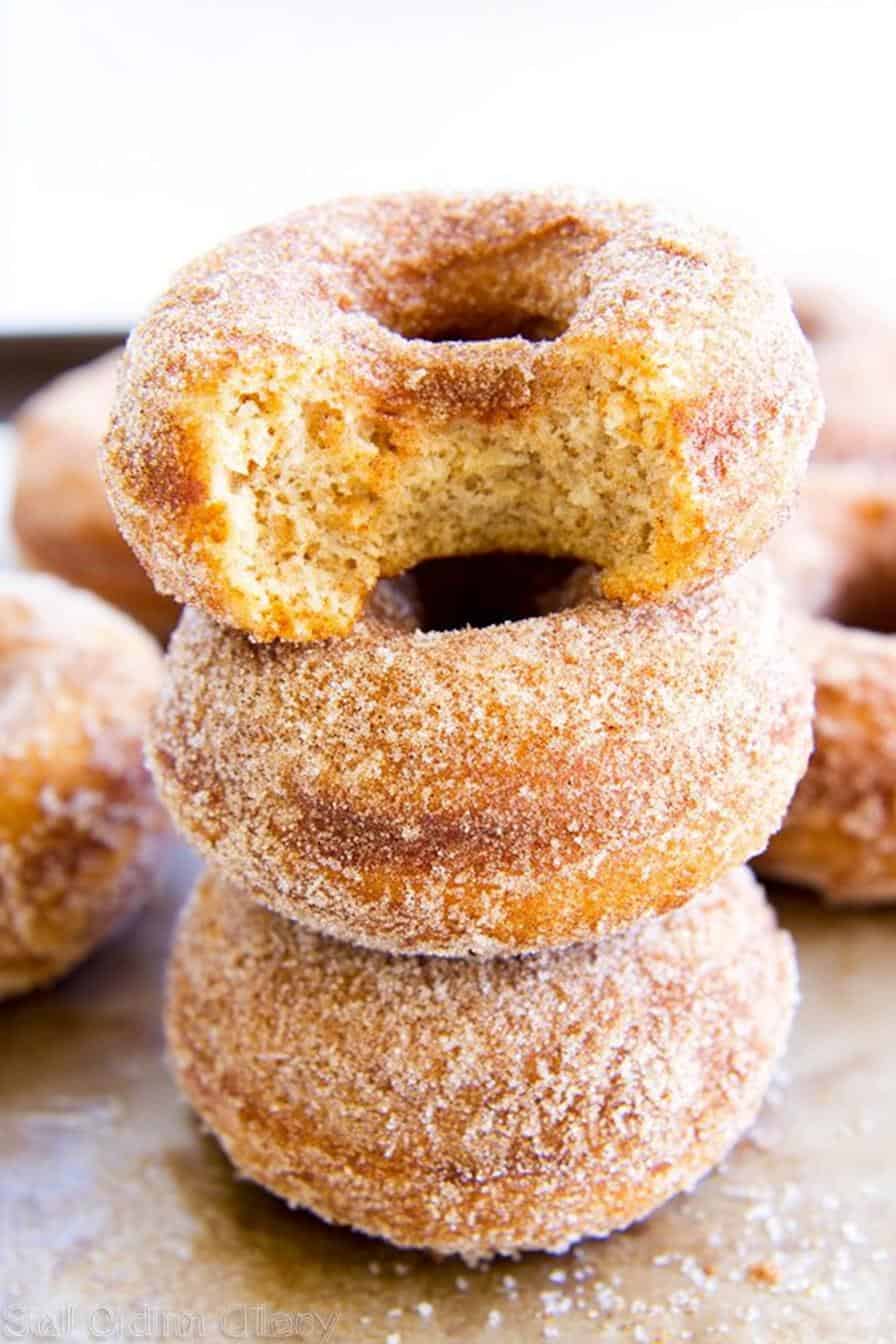 Sweet cinnamon sugar donut holes stacked in a close-up shot, showcasing their golden-brown crispy exterior and soft, fluffy interior. Perfect for breakfast, snacks, or dessert, these homemade donut holes are irresistibly delicious and easy to make.