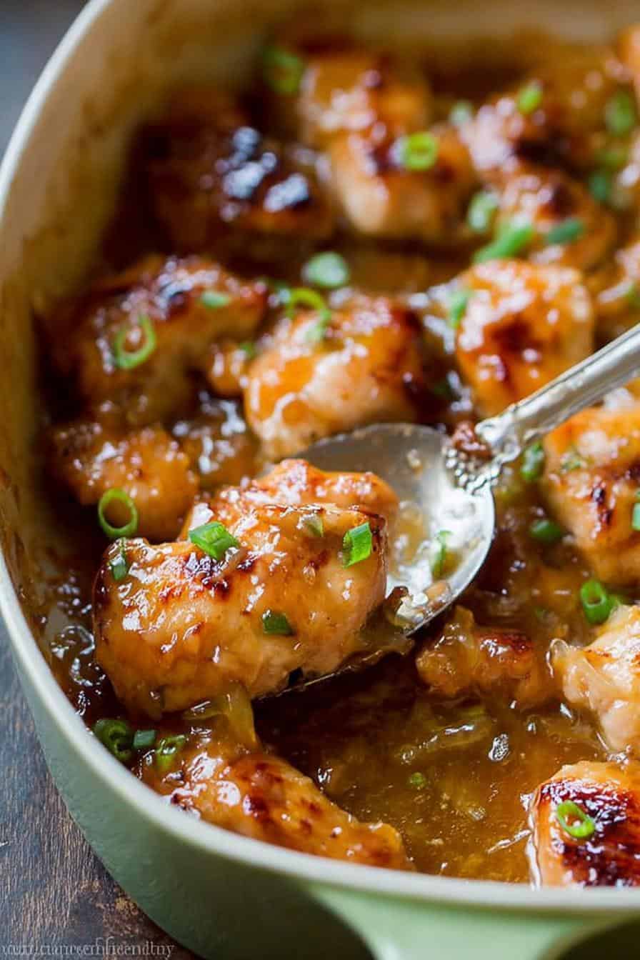 Savory honey glazed chicken thighs garnished with chopped green onions in a flavorful sauce. Perfect comfort food for dinner or special occasions.
